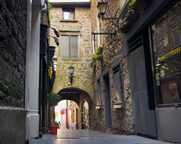 KILKENNY, IRELAND - MAR 28: Historic Butter Slip passageway in Medieval Kilkenny, Ireland on Mar 28, 2013. This narrow arched alley was built in the 1600's and was once lined with butter stalls.