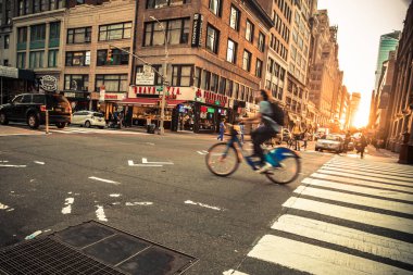 New York City, New York - June 14, 2018:  View of busy midtown Manhattan Street with vehicles at sunset photographed on Broadway.