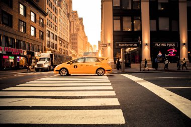 New York City, New York - June 14, 2018:  View of busy midtown Manhattan Street with vehicles at sunset photographed on Broadway.