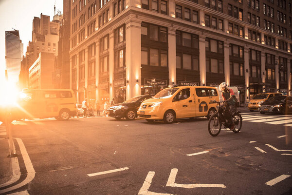 New York City, New York - June 14, 2018: View of busy midtown Manhattan Street with vehicles at sunset photographed on Broadway.