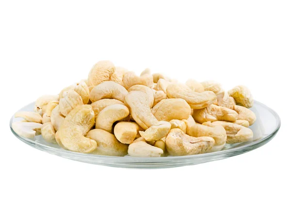 Saucer with a row cashew nuts isolated on white background — Stock Photo, Image