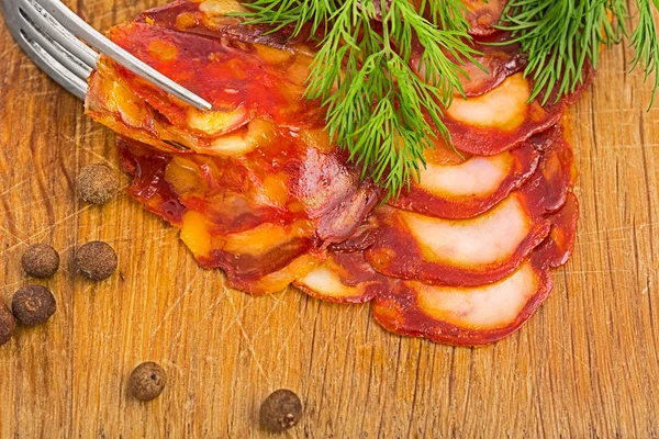 Rustic still life with a slice of sausage — Stock Photo, Image