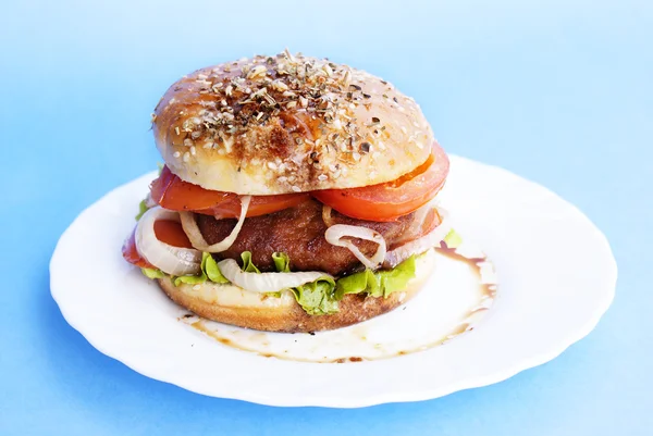 Burger with meat and baked vegetables on a blue background — Stock Photo, Image