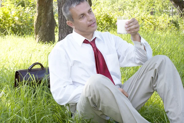 Businessman drinks milk — Stock Photo, Image