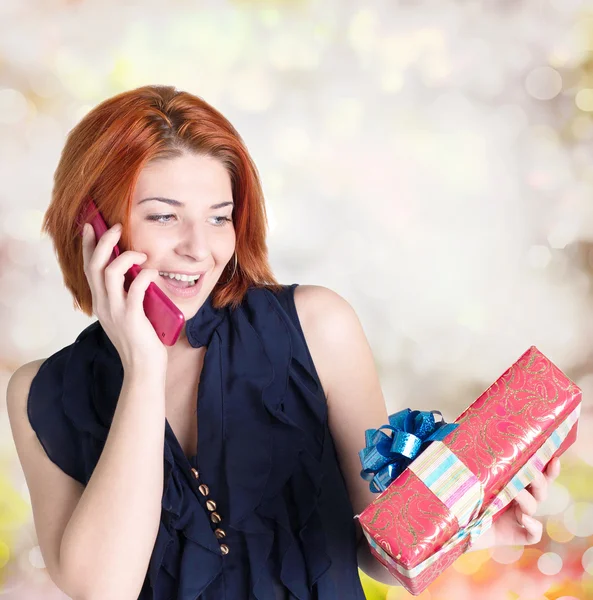 Happy smiling red-haired woman with boxes gifts and phone.Christmas — Stock Photo, Image