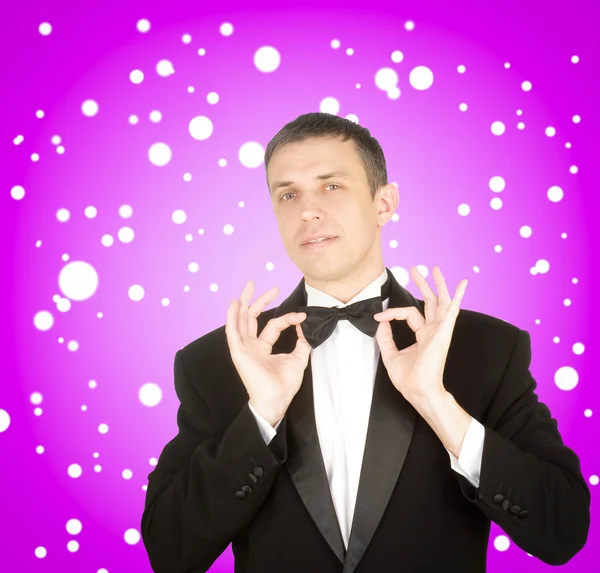 Portrait the man in a classical tuxedo on an festive background — Stock Photo, Image