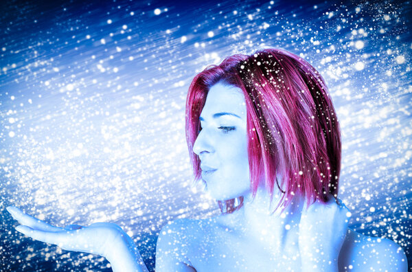Girl winter cold beauty on abstract blue background with white snow flying