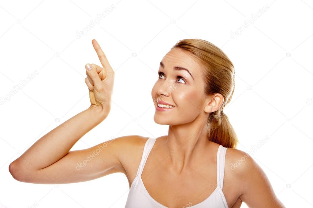 Excited woman pointing above her head