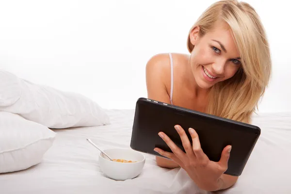 Blonde using tablet blonde using tablet Stock Photo