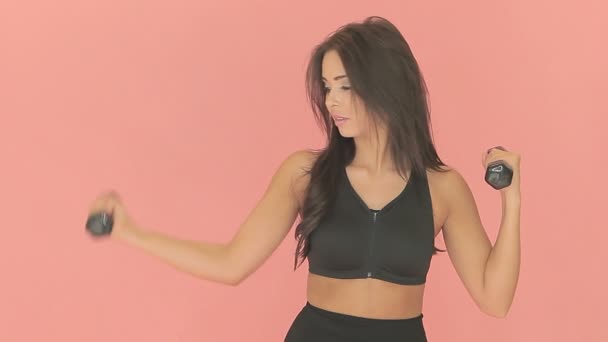 Fit woman exercising with dumbbells — Stock Video