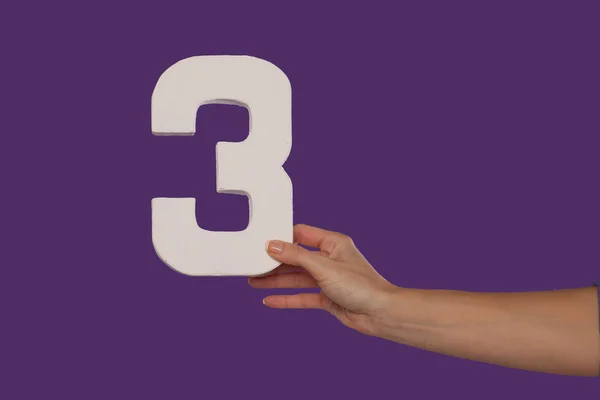 Female hand holding up the number 3 from the right — Stock Photo, Image