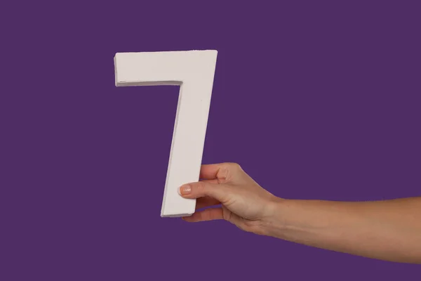 Female hand holding up the number 7 from the right — Stock Photo, Image