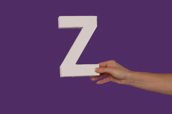 Female hand holding up the letter Z from the right — Stock Photo, Image