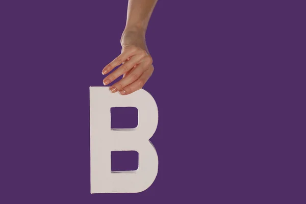 Female hand holding up the letter B from top — Stock Photo, Image