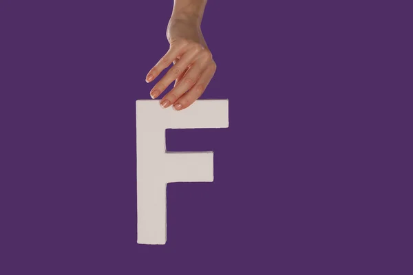 Female hand holding up the letter F from top — Stock Photo, Image