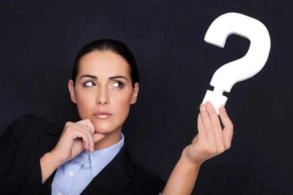 Businesswoman holding a question mark — Stock Photo, Image