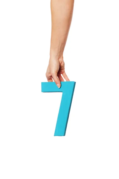 Mão segurando o número sete a partir do topo — Fotografia de Stock