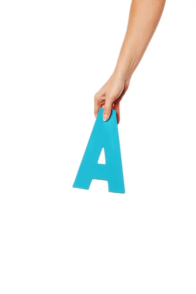 Hand holding up the letter A from the top — Stock Photo, Image