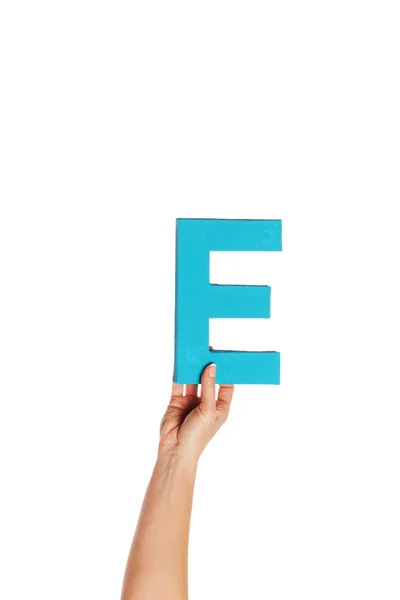 Hand holding up the letter E from the bottom — Stock Photo, Image