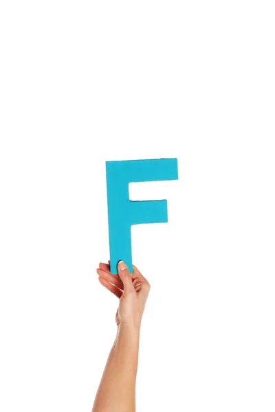 Hand holding up the letter F from the bottom — Stock Photo, Image