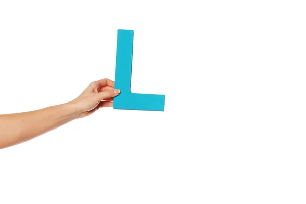 Hand holding up the letter L from the left — Stock Photo, Image