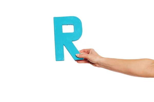 Hand holding up the letter R from the right — Stock Photo, Image