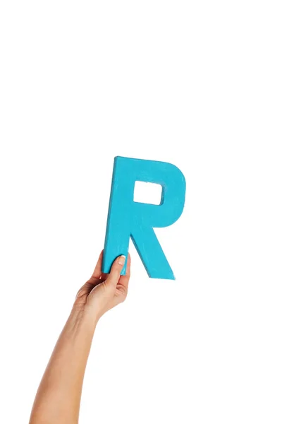 Hand holding up the letter R from the bottom — Stock Photo, Image