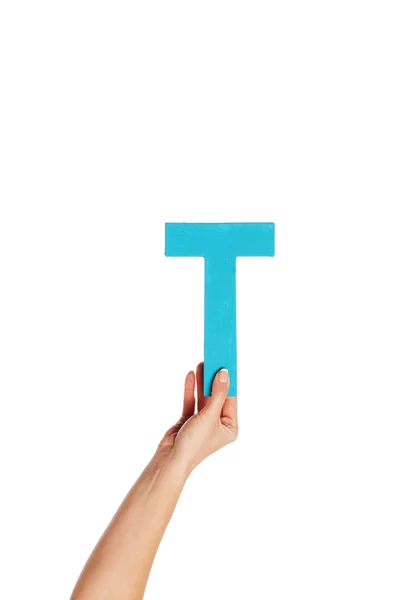 Mão segurando a letra T a partir do fundo — Fotografia de Stock