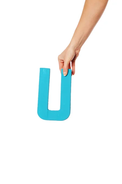 Mão segurando a letra U a partir do topo — Fotografia de Stock