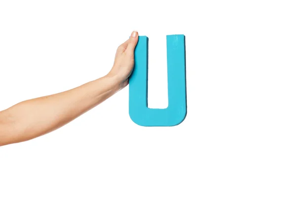 Hand holding up the letter U from the left — Stock Photo, Image