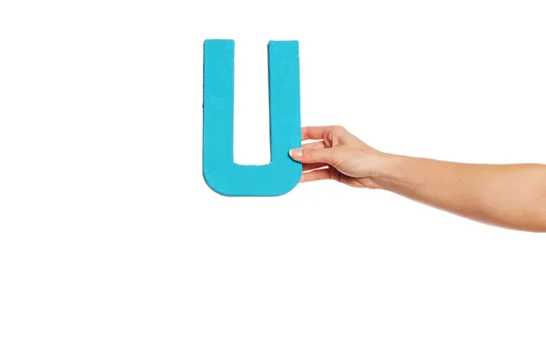 Hand holding up the letter U from the right — Stock Photo, Image