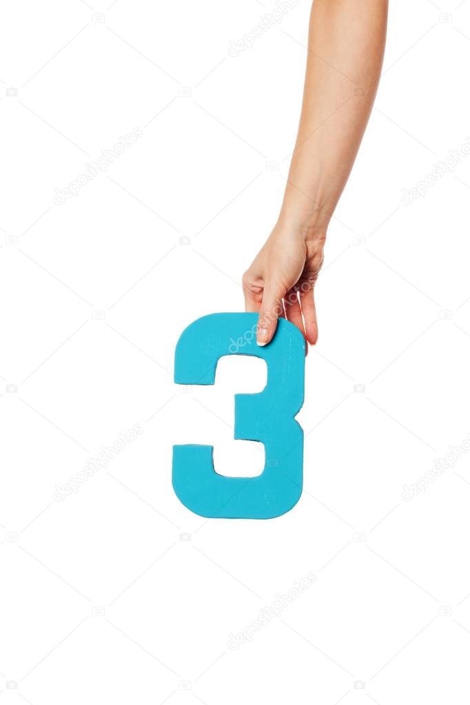 hand holding up the number three from the top
