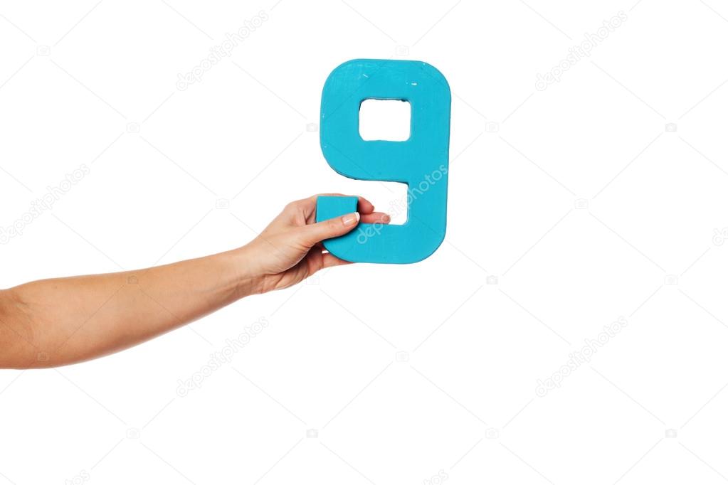 hand holding up the number nine from the left