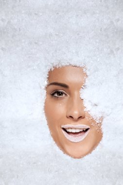 Laughing woman appearing through snow clipart
