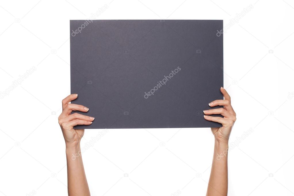 Woman's arms holding chalkboard