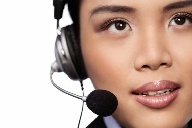 Closeup of an Asian lady wearing a headset clipart
