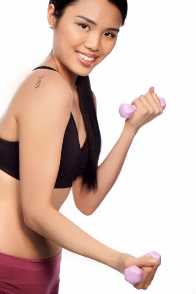 Beautiful Asian woman using dumbbells — Stock Photo, Image