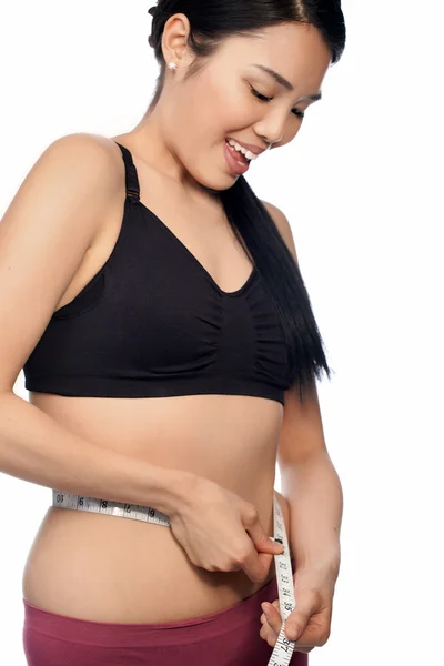 Asian woman measuring her waist — Stock Photo, Image