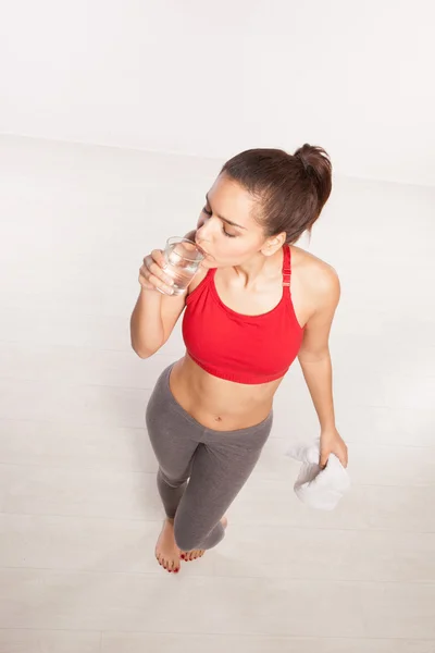 Thirsty woman drinking a glass of water — Stock Photo, Image