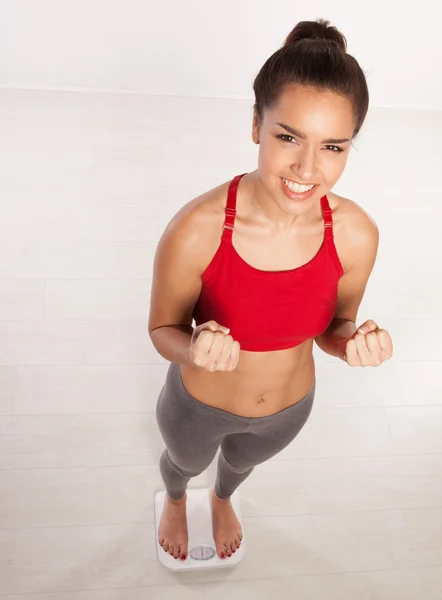 Happy motivated woman on a scale — Stock Photo, Image