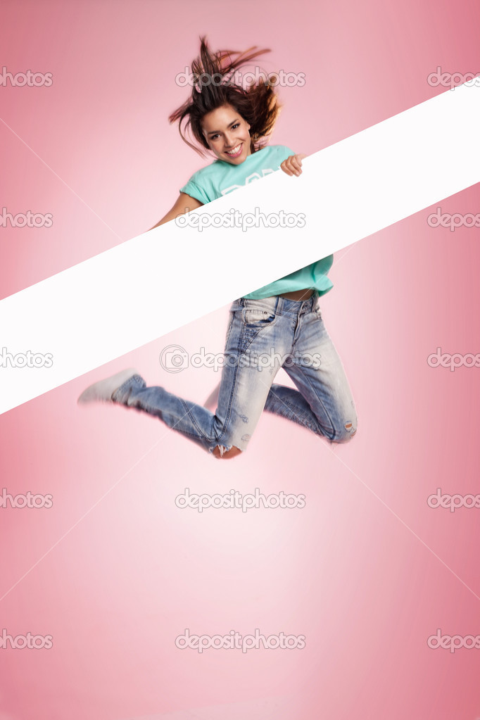 Woman jumping midair with a blank banner