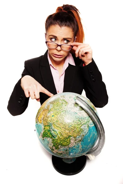 Businesswoman looking dumb pointing to a globe Stock Picture