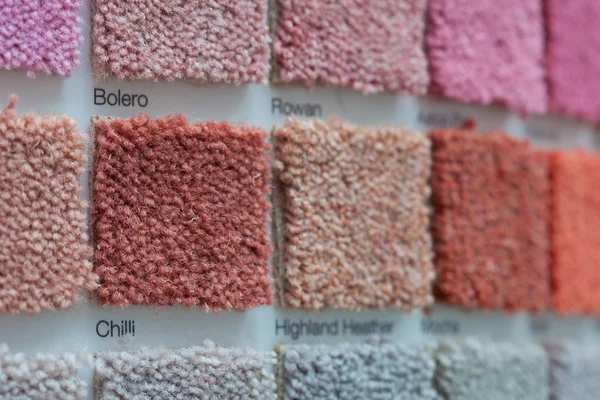Carpet samples in shades of red, orange and pink — Stock Photo, Image