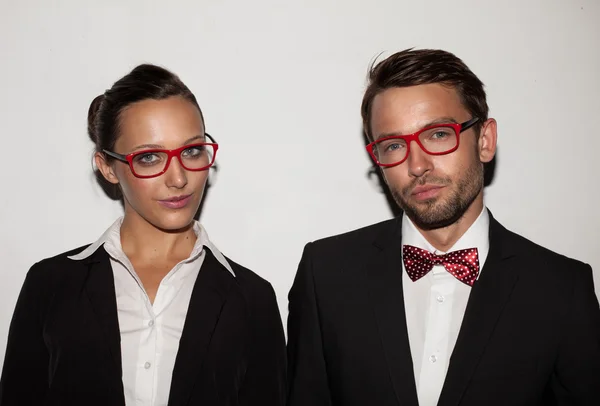 Couple of students wearing red glasses — Stock Photo, Image
