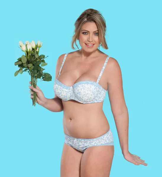 Donna in lingerie che porta fiori — Foto Stock