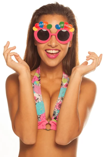 Girl celebrating wearing birthday sunglasses on white — Stock Photo, Image