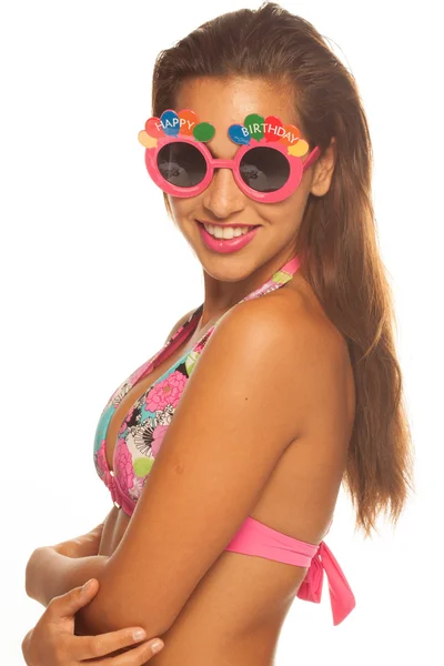 Girl celebrating wearing birthday sunglasses on white — Stock Photo, Image