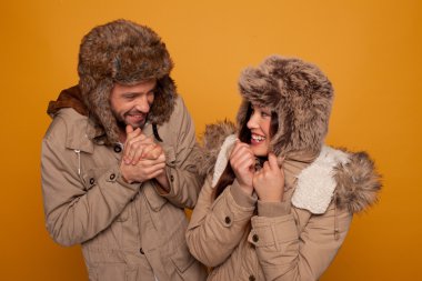 Happy couple in warm winter clothing clipart