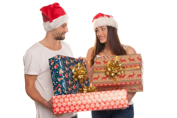 Smiling young couple with large Xmas gifts — Stock Photo, Image