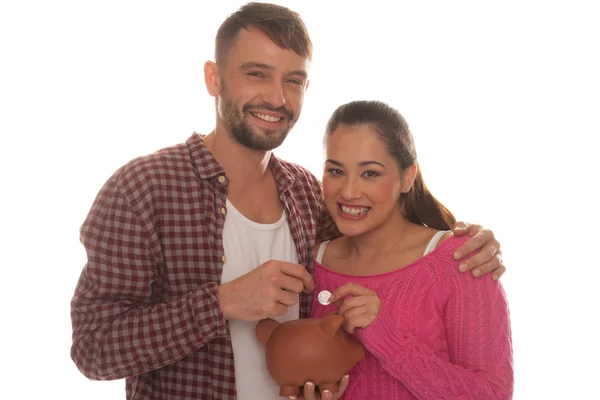 Young couple with their piggy bank — Stock Photo, Image